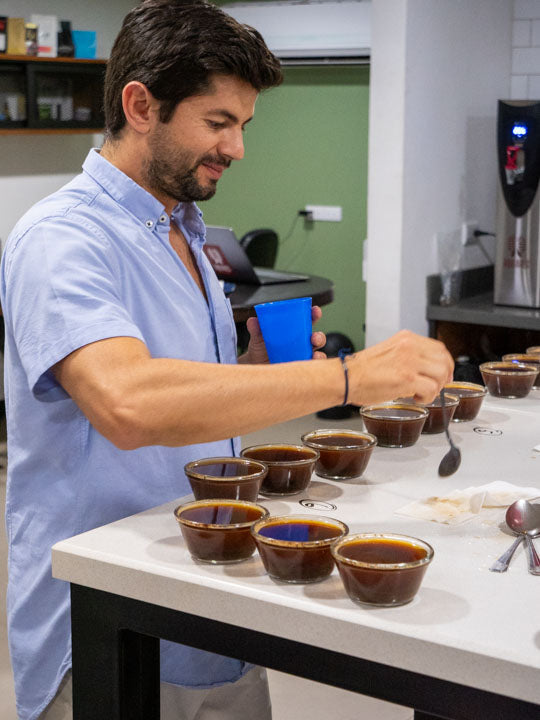 Farm manager Diego Robelo tastes through several lots of coffees in the quality lab at Aquiares Estate, Costa Rica.
