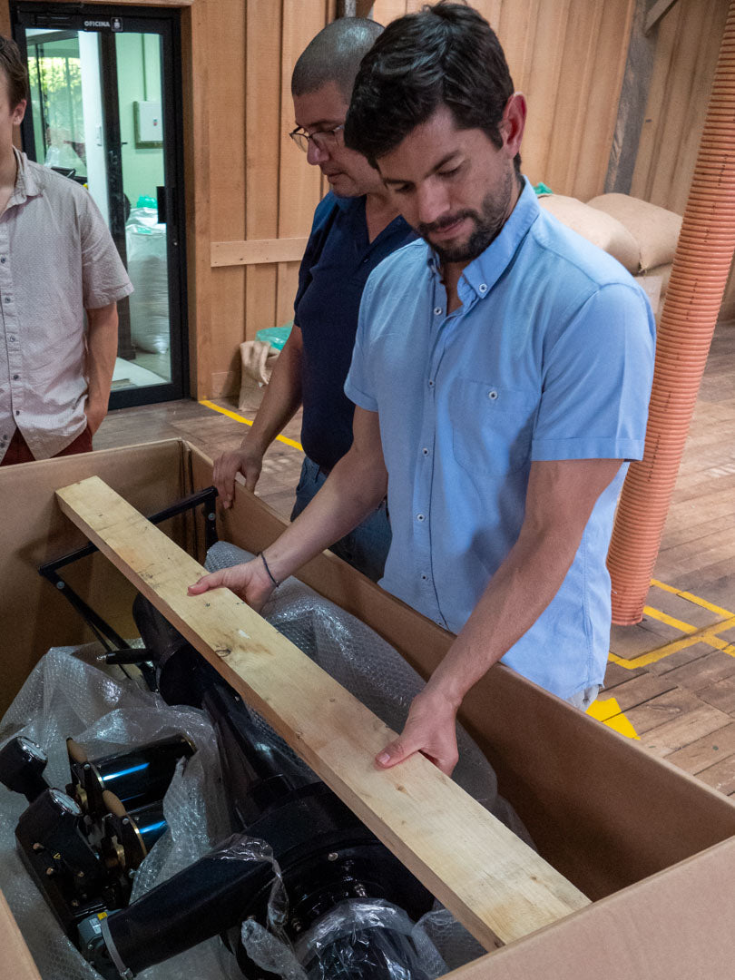 Farm manager Diego Robelo unboxes some new coffee roasting equipment in the quality control lab at Aquiares Estate, Costa Rica.