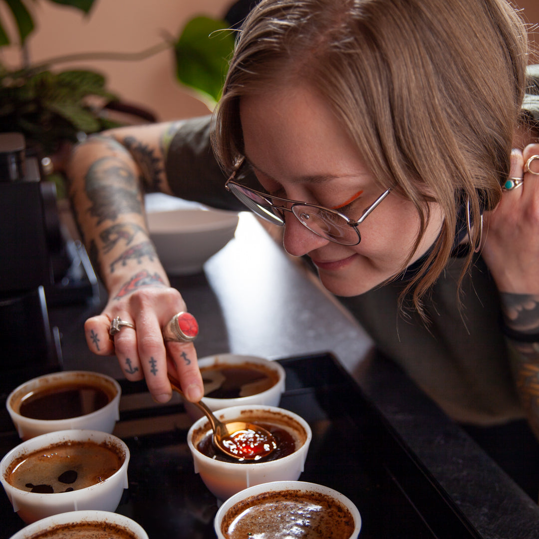 The team at Loom Coffee Co. engaged in cupping for quality control at the roasting facility.